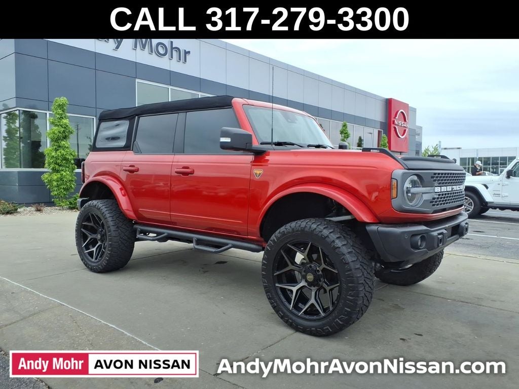 2023 Ford Bronco Badlands in Hot Pepper Red Metallic Tinted Clearcoat — front three-quarter view